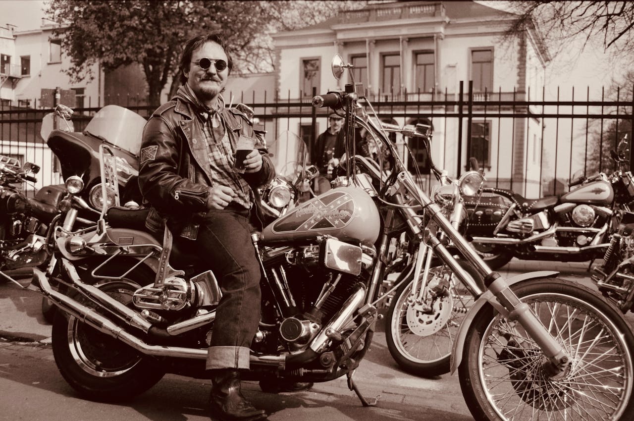 services-img Man on a motorcycle enjoying urban landscape. Vintage style photograph.